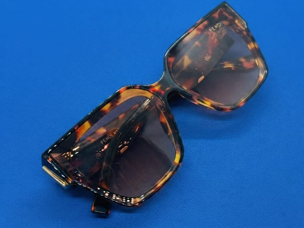 A square, oversized frame with a classic tortoise shell